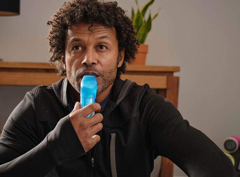 man training his breathing with POWERbreathe