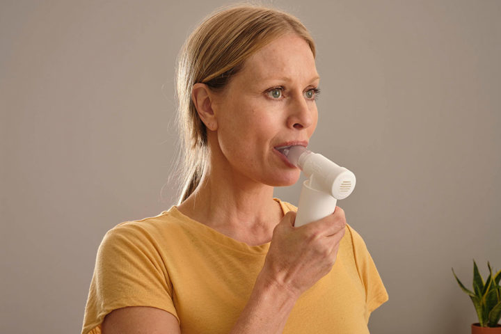 photo of lady using POWERbreathe Medic