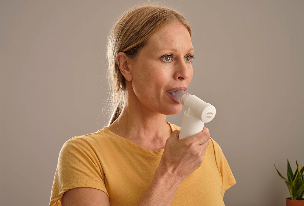 photo of lady using POWERbreathe Medic