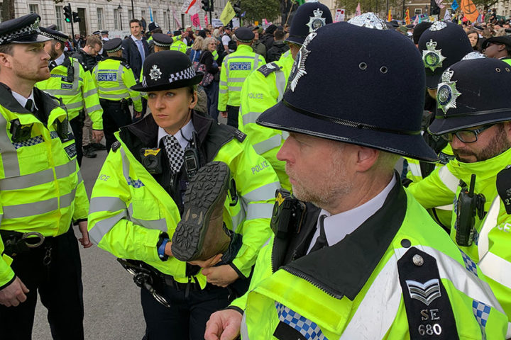 There are a number of police officers carrying a protester away in the city.