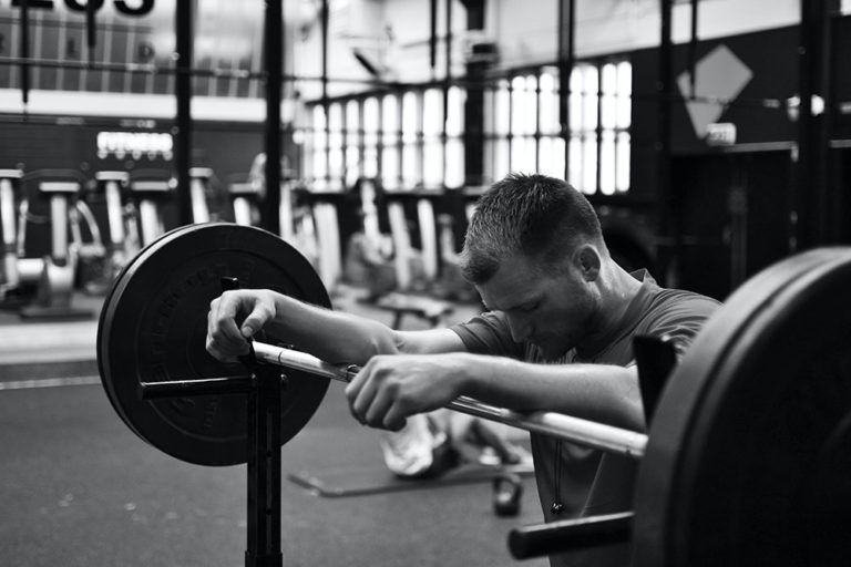 Man focusing before lifting heavy weights at gym