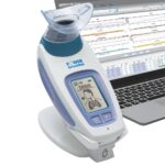 The POWERbreathe KH2 offers a professional level of breathing training, testing and monitoring. Shows a partial laptop next to it.