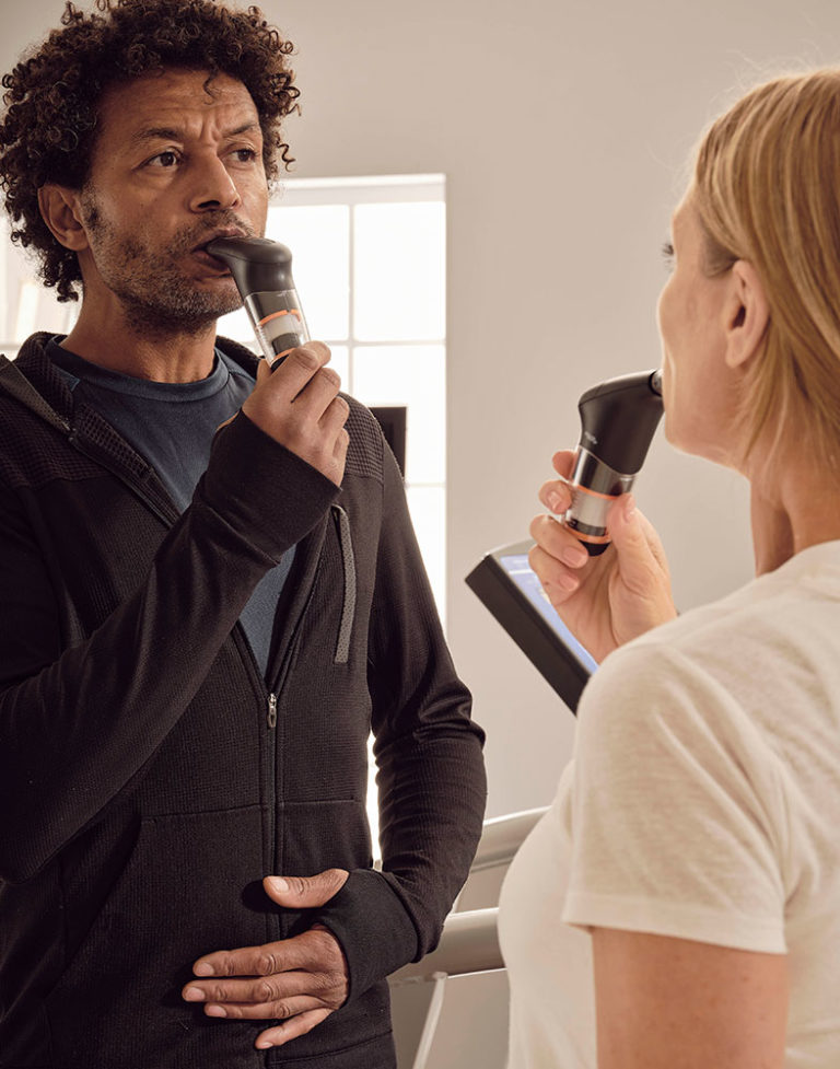man and woman performing breath work