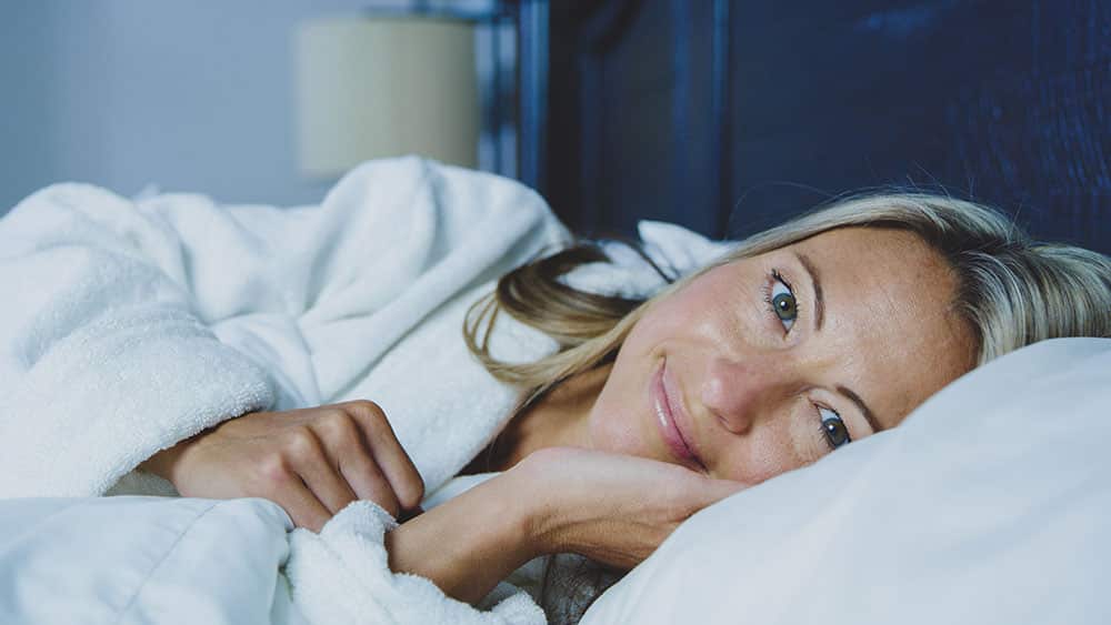 lady lying in bed smiling