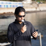 Person using the Smart Adaptor to train their breathing muscles at the seaside