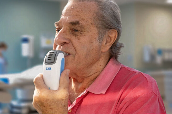 Older adult using POWERbreathe K3 IMST device to lower blood pressure naturally