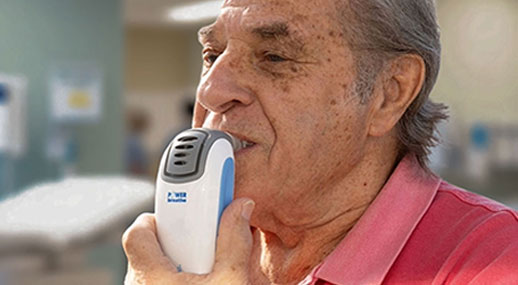 older adult using POWERbreathe K3 IMST device