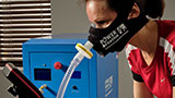 Person training on an indoor bike with mask on and connected to a hypoxic air generator