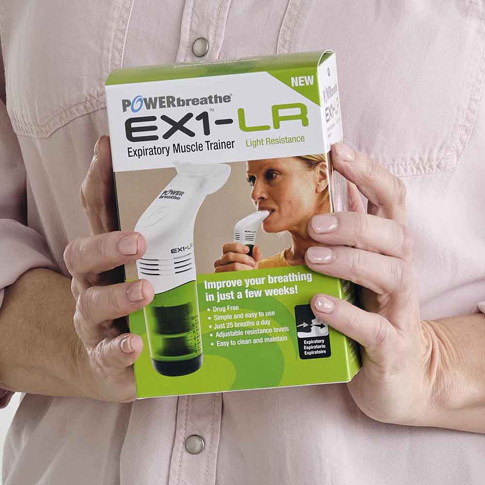 Close up of a woman holding t retail packaging of an EX1