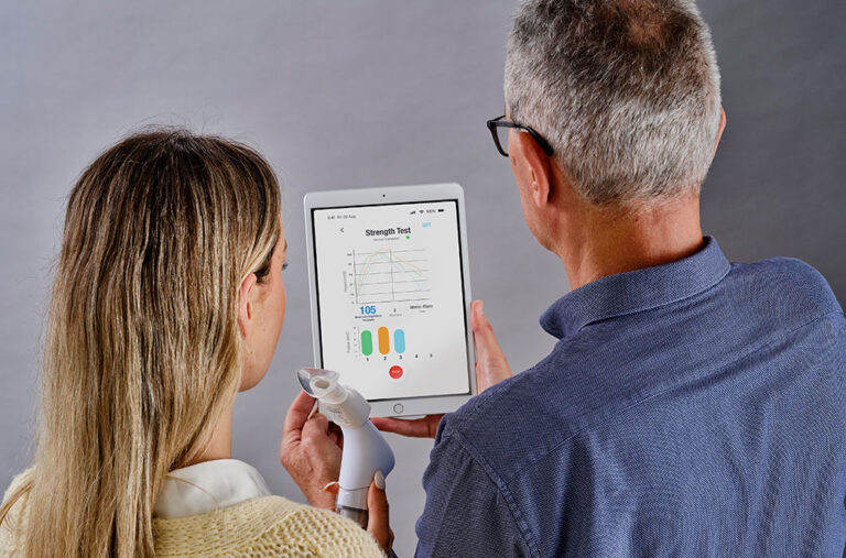 Two people viewing the POWERbreathe ActiBreathe app on iPad.