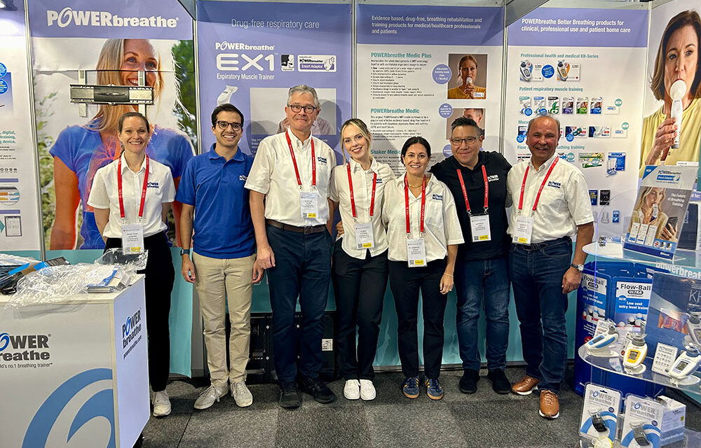 POWERbreathe team standing in front of display material, smiling to camera, while at ERS