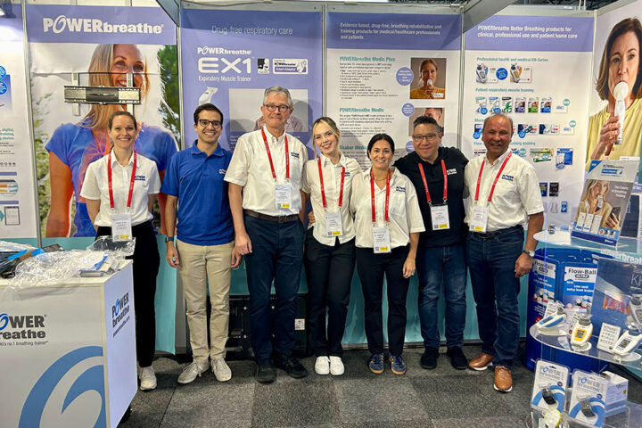 POWERbreathe team standing in front of display material, smiling to camera, while at ERS