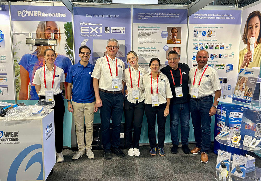 POWERbreathe team standing in front of display material, smiling to camera, while at ERS