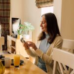 A woman sat at a breakfast table using K-Series