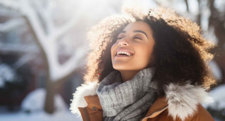 Person outside in the cold, smiling, breathing in the fresh New Year air.