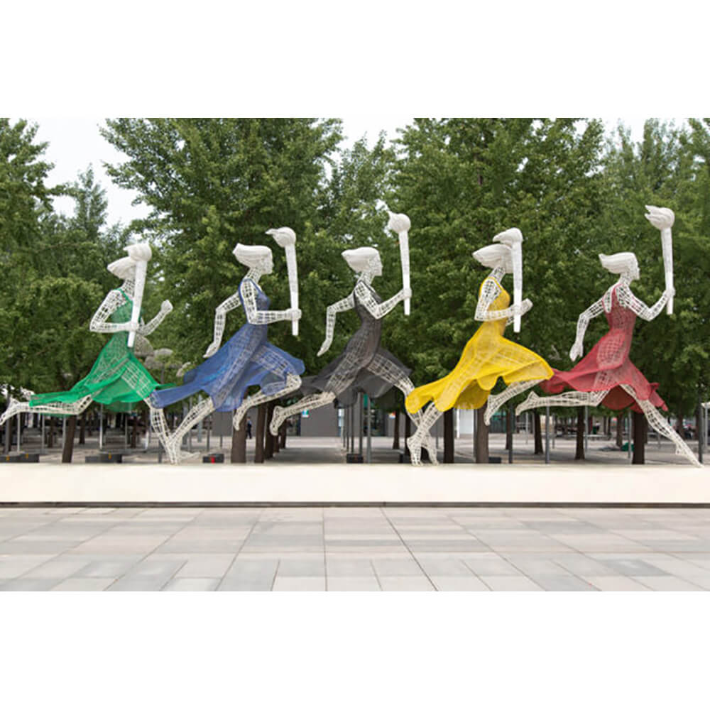 5 sculptures running with the olympic flame in different coloured dresses