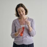 A woman who looks like she is attaching the tube to a Breath Builder